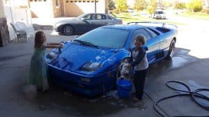 kids washing the 1999 Lamborghini Diablo